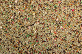A close-up of Canary Roller Cuisine bird food, showing a mix of seeds, grains, and colorful morsels, indicative of a nutritious blend designed for canaries.