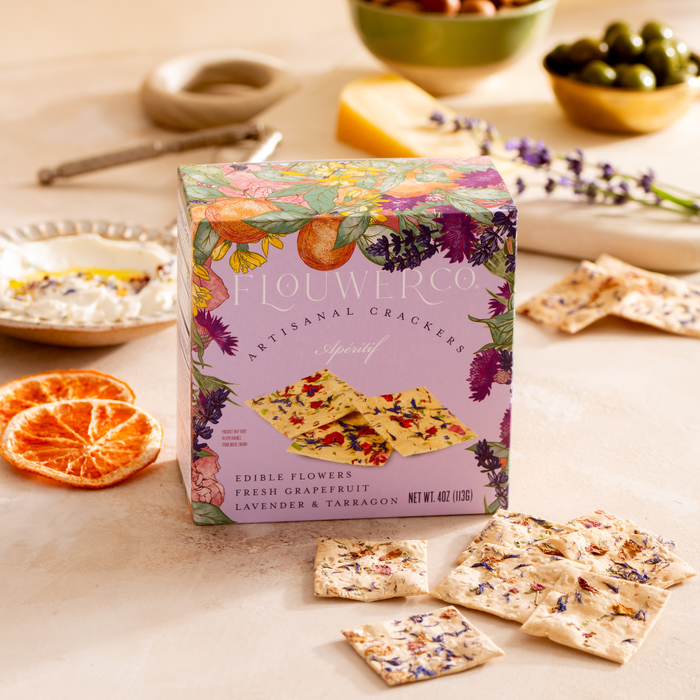 Flouwer Co. Artisanal Crackers in the Apéritif flavor, featuring edible flowers, fresh grapefruit, lavender, and tarragon