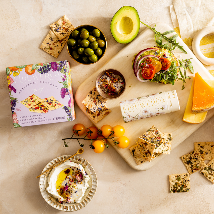 Elegantly styled grazing board featuring the Apéritif Artisanal Crackers box and product line by Flouwer Co.