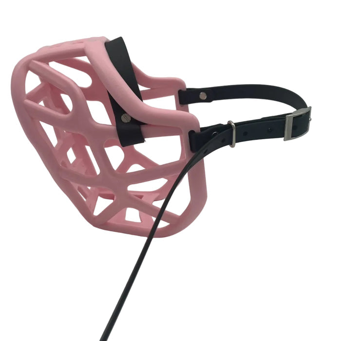 The Muzzle Movement Pastel Pink Harry 2.0 dog muzzle with black straps and nickle hardware with chicago screws on a white background