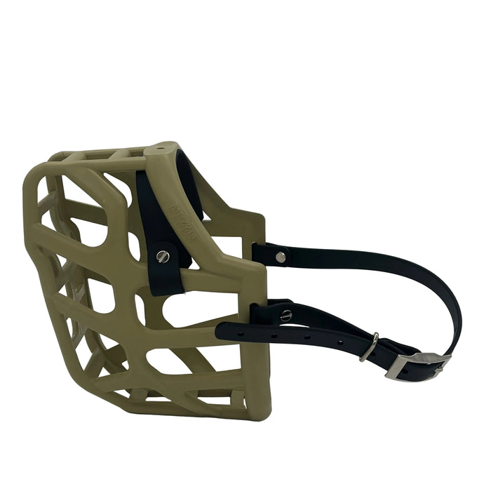 The Muzzle Movement Khaki Taz dog muzzle with black straps and chicago screws on a white background