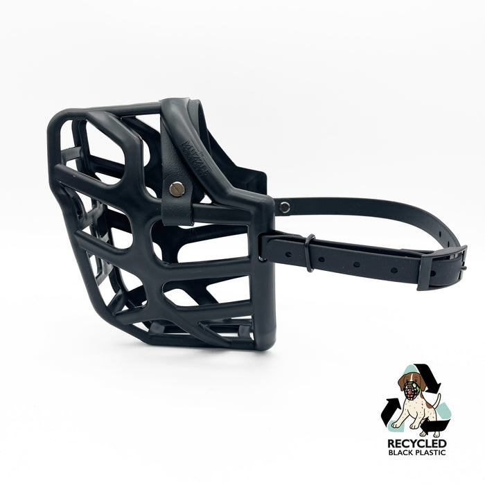 The Muzzle Movement Black Taz dog muzzle with black straps and black hardware with chicago screws on a white background