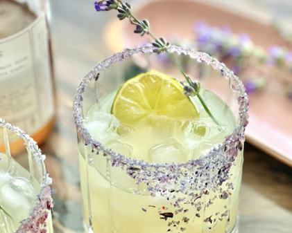Lavender Margarita served in a glass rimmed with lavender-infused finishing sugar